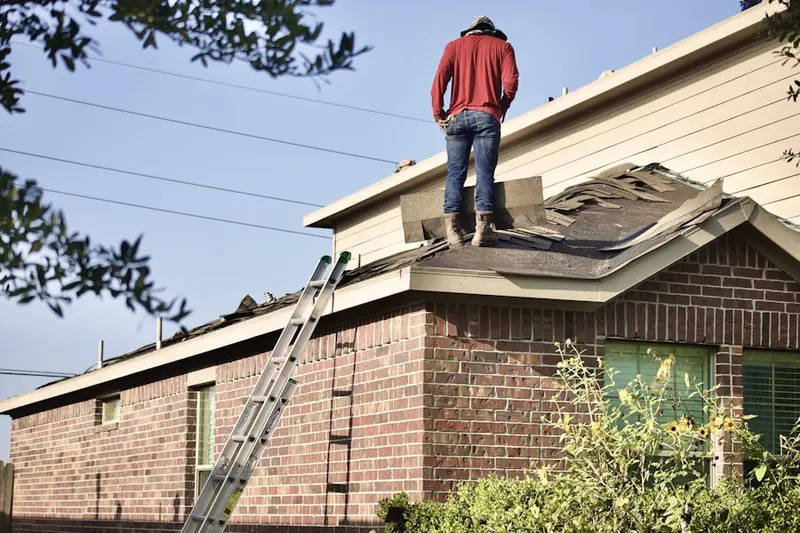 Professional roofer working on a residential roof in Lake Frederick